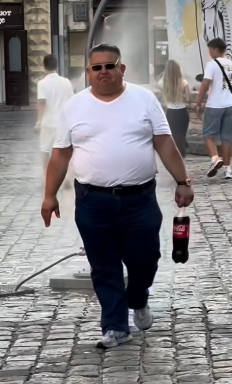 Slava Pomidor walking with a Coca-Cola bottle